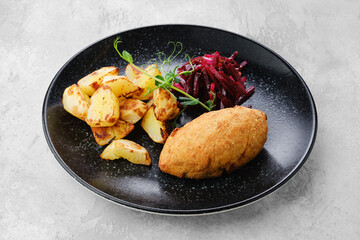 Kiev or pozharskaya cutlet served with fried potato and beet