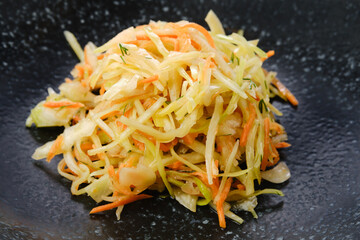 Pickled slices of cabbage and carrot, closeup view