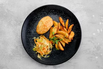 Foto auf Acrylglas Kiev cutlet stuffed with cheese and butter served with potato wedges and sauerkraut, top view © boomeart