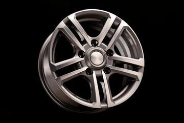 alloy wheel, shiny with gray on black background close-up