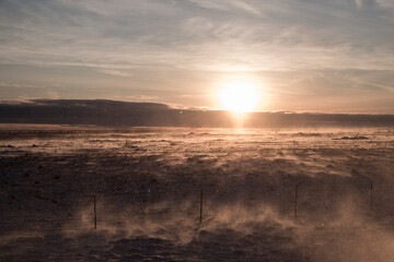 Wind blows over an evening winter landscape near Hella - South Iceland