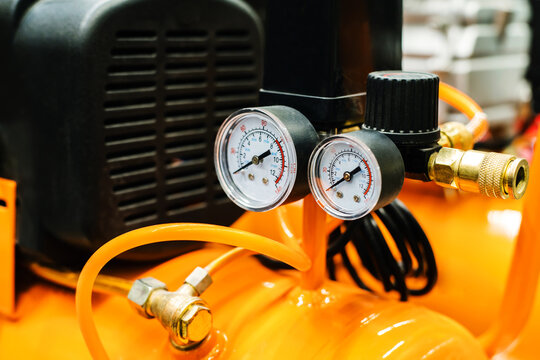 Pressure sensors on a portable, air compressor. Оquipment for compressing and supplying pressurized air. Close-up