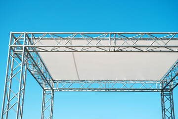 Fragment of a metal structure with a roof made of pvc material. A small stage for mass events in the open air. Close-up