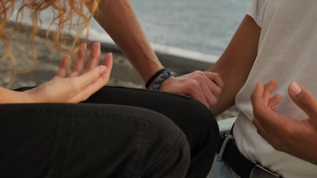 Couple having a great time on a dock at the beach, close up of latino and caucasian multi-ethnic boyfriends