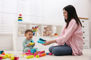 Cute baby boy playing with mother and building blocks on floor at home - Powered by Adobe