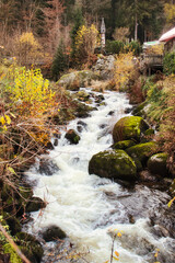 Stream rapidly flowing through the town of Triberg in the Black Forest of Germany on a fall day.