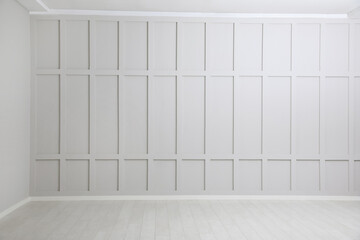Empty spacious room with white wooden floor and walls