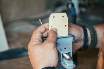 Fototapeta premium An Anonymous Carpenter Using Table Clamp in his Workshop