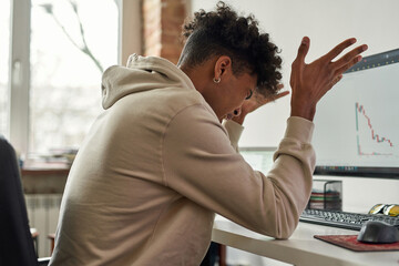 African american stock trader shocked after stock market crash