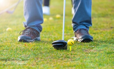 Fototapeta premium Man practicing swing on a green golf course. golf training