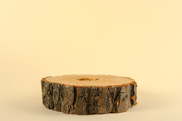 wooden podium for presentation eco beauty cosmetics, one sawn on beige background