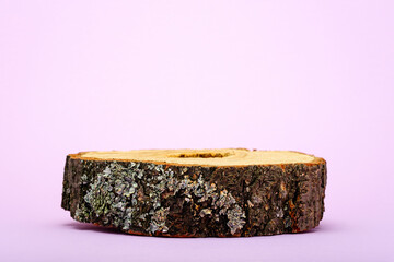 trendy wooden podium on very peri background, sawn with bark, eco scene for presentation of beauty products