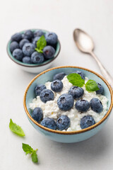 Cottage cheese with blueberry, fresh berries, keto healthy breakfast concept, top view.