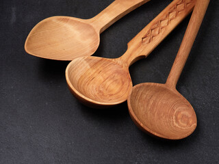handmade wooden spoons on a dark background