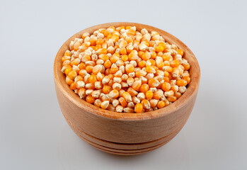 Dry corn seeds in wooden bowl,top view