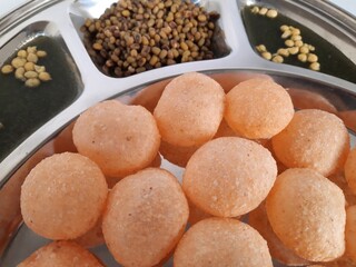 Indian pani puri with spicy water and boiled moong