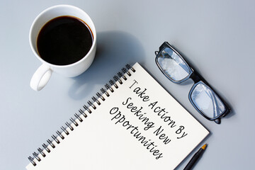 Motivational quote on notepad - Take action by seeking new opportunities.