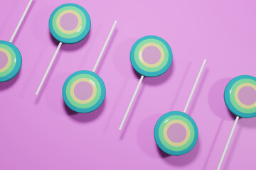 Colorful pastel lollipops flat lay on pink background. 3d rendering.