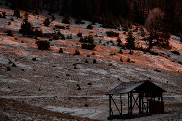 Idylic sunset light over Bucegi Mountains, Romania. Fundata village landscape