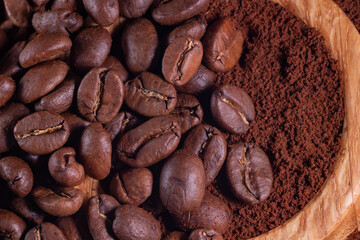 Coffee beans on ground coffee background