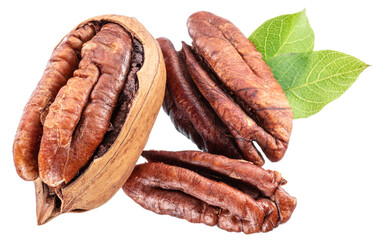 Shelled and cracked pecan nuts with leaves close-up on white background.