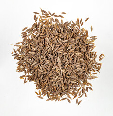 Aroma  spice cumin is scattered on a white isolated background. Top view