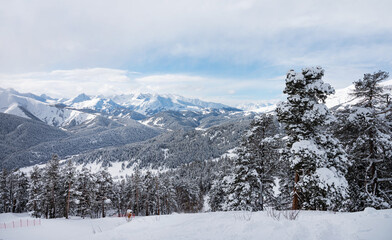 Beautiful landscape of the Arkhyz ski resort with mountains, snow and forest on a sunny winter day. Caucasus Mountains, Russia