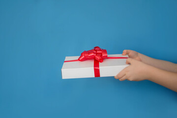 hand holding a gift box. Gift box in hands. St. Valentine's Day. Mothers Day. March 8. New Year.