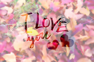 I love you beautyful lettering. Calligraphy text with red heart. Background from autumn leaves