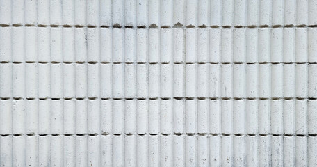 white corrugated brick wall background in curve pattern, retro Brick wall background for exterior. old vintage brick wall backdrop, old texture of white stone blocks