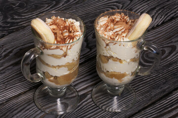 Dessert with Savoiardi cookies and cream. Tiramisu cookies. Close-up.