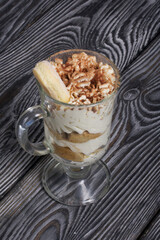 Dessert with Savoiardi cookies and cream. Tiramisu cookies. Close-up.