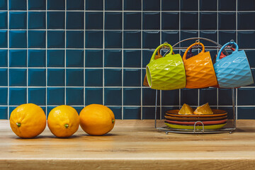 three yellow lemons in the kitchen and a tea set