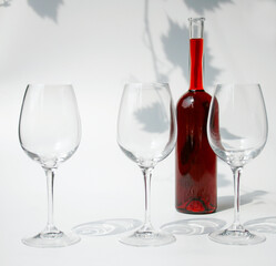 three glasses and a bottle of wine