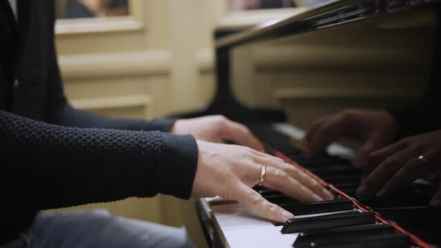 A man masterfully plays the piano, close-up