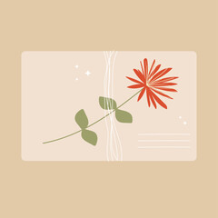 An envelope tied with a thread of kraft paper with a wildflower.