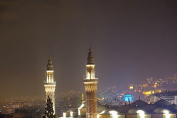 Fototapeta na wymiar Bursa at night. Blue tomb local name is yesil turbe and illuminated grand mosque local name is ulu cami at evening and aerial view.