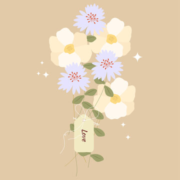 A bouquet of tied wildflowers with a note - LOVE.