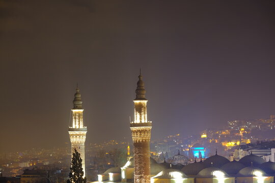 Bursa at night. Blue tomb local name is yesil turbe and illuminated grand mosque local name is ulu cami at evening and aerial view.
