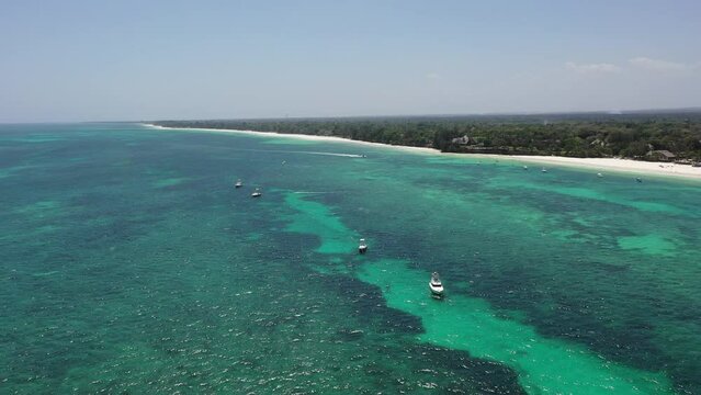 Drone Coastline Diani beach landscape Kenyan African Sea  aerial 4k waves blue indan ocean tropical mombasa turquoise white sand East Africa palms paradise view Wood boats on water kite surfing