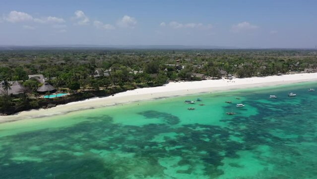 Drone Coastline Diani beach landscape Kenyan African Sea  aerial 4k waves blue indan ocean tropical mombasa turquoise white sand East Africa palms paradise view Wood boats on water kite surfing