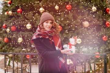 Christmas. Girl in winter clothes at the Christmas market. 