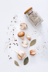 Spices and vegetables on light grey background, top view.
