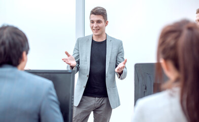 young businessman explaining something to the office staff.