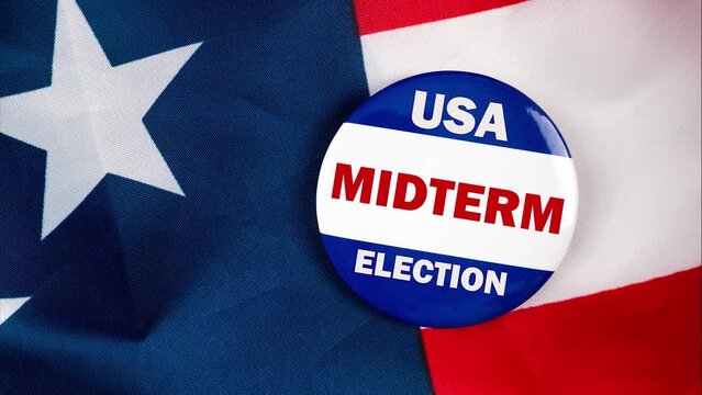 usa midterm election text quote on election button laying on the star spangled banner. united states of america concept.