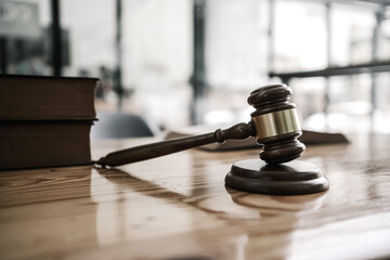 Close up wooden gavel and book of law put on desk table.
