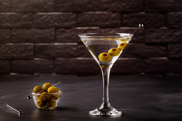 Martini cocktail on dark stone table.