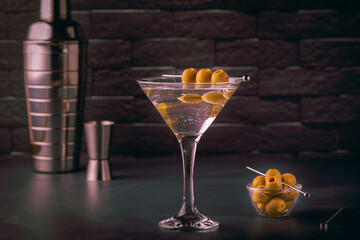 Martini cocktail on dark stone table.