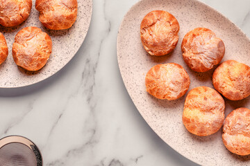 Homemade profiteroles with powdered sugar.