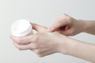 Woman applying cream on hand